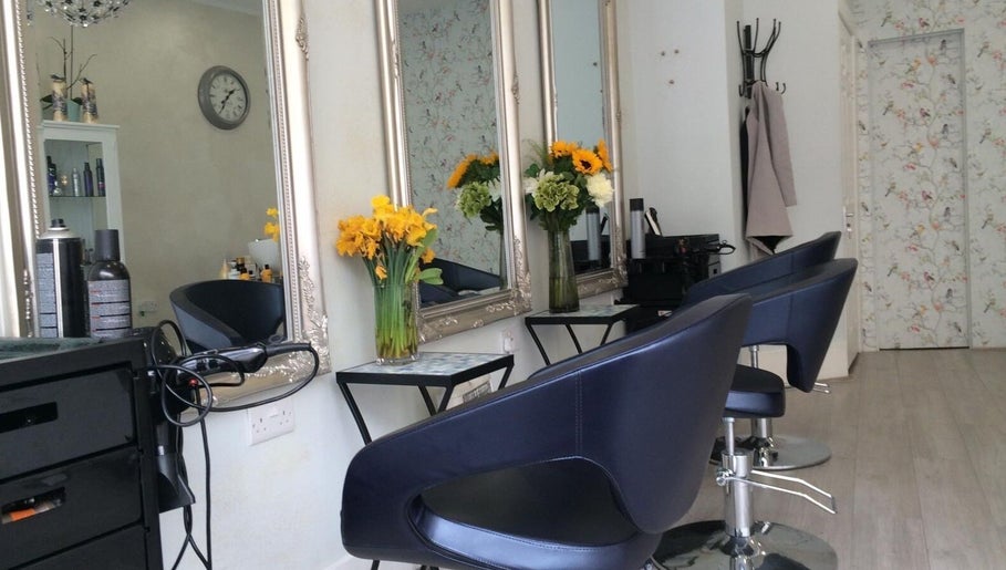 Elegant salon chairs and floral decor in Studio 75, London, England, GB, providing a serene beauty experience.