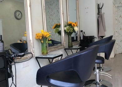 Elegant salon chairs and floral decor in Studio 75, London, England, GB, providing a serene beauty experience.