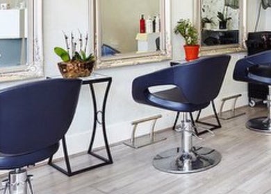 Elegant interior of Studio 75 in London, England, GB with sleek salon chairs and mirrors.