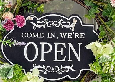 Studio 75 open sign with floral decor at London, England, GB.