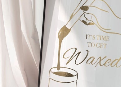 Golden wax-themed art at Studio 75, London, England, GB, promoting beauty and wellness services.