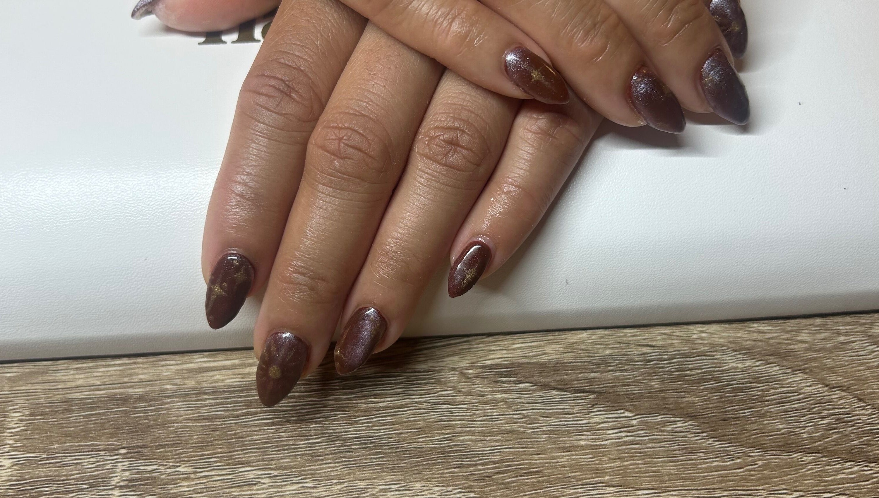 Stylish brown nail art at Navy, Halesworth, England, GB, showcasing detailed craftsmanship.