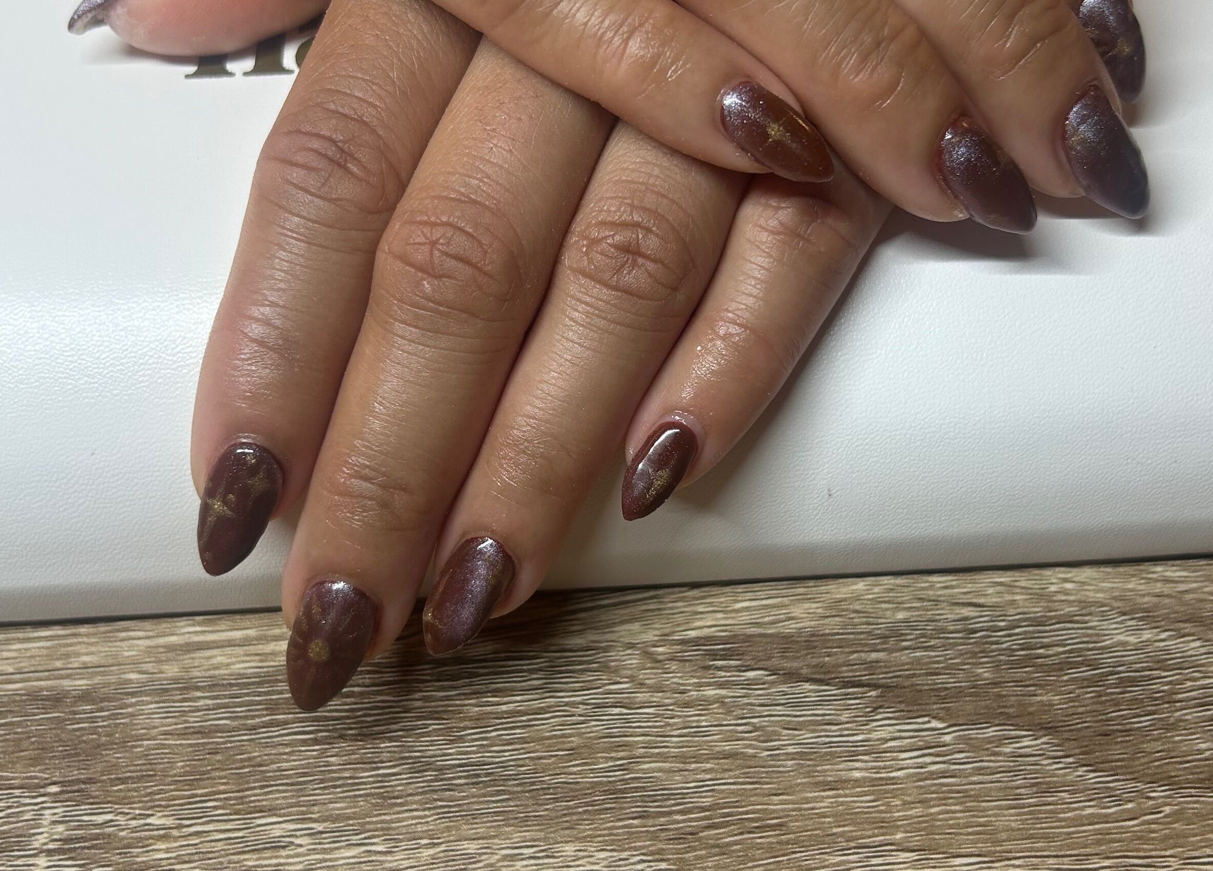 Stylish brown nail art at Navy, Halesworth, England, GB, showcasing detailed craftsmanship.