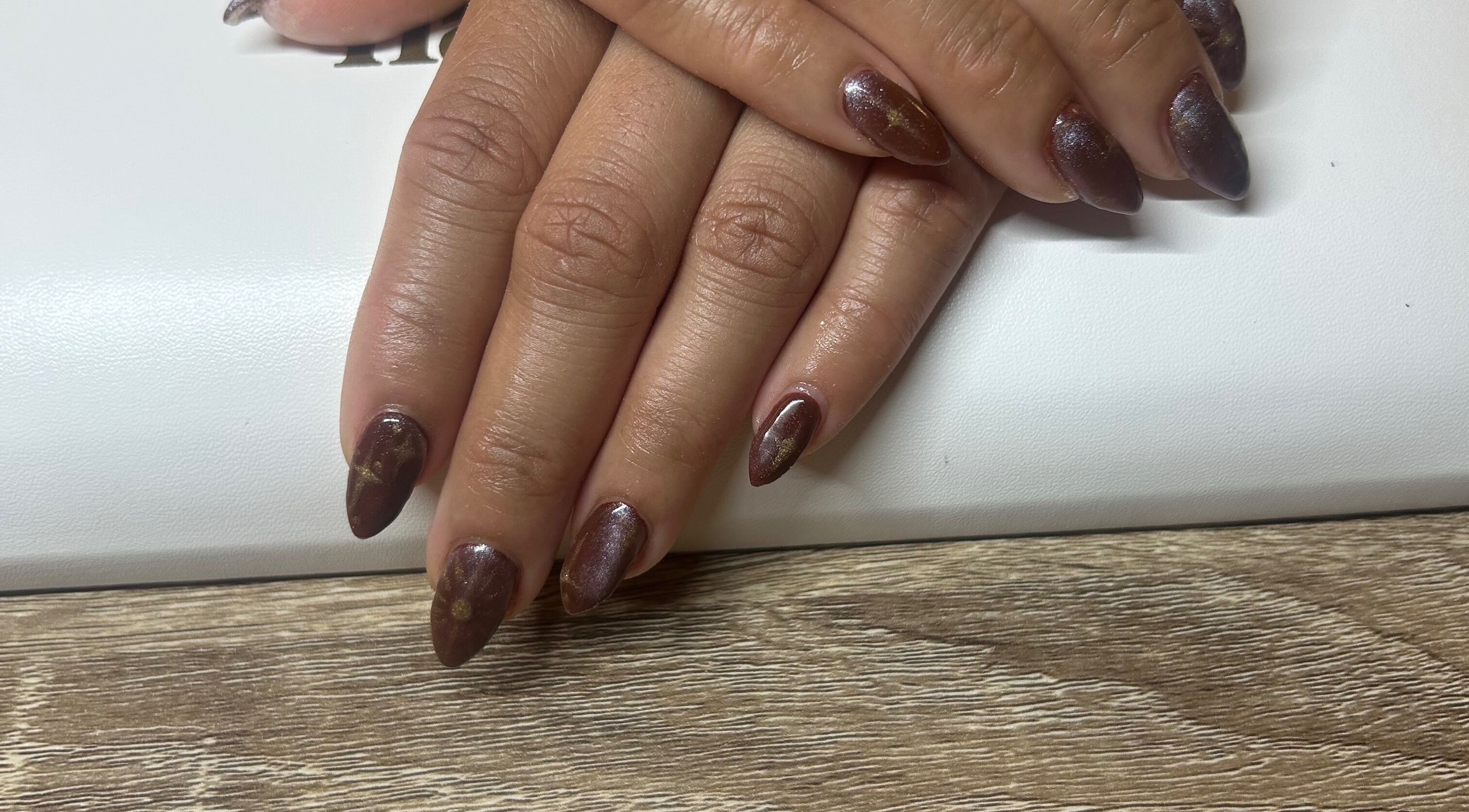 Stylish brown nail art at Navy, Halesworth, England, GB, showcasing detailed craftsmanship.