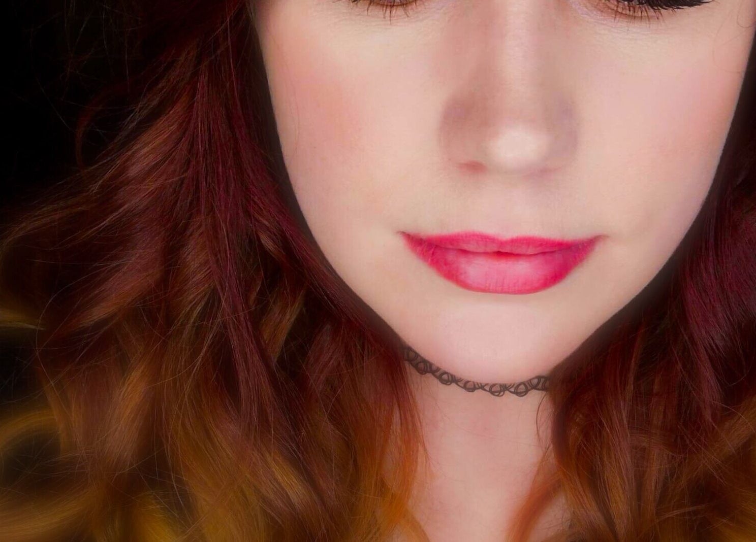 Close-up of a woman's face with vibrant hair at Navy, Halesworth, England, GB.