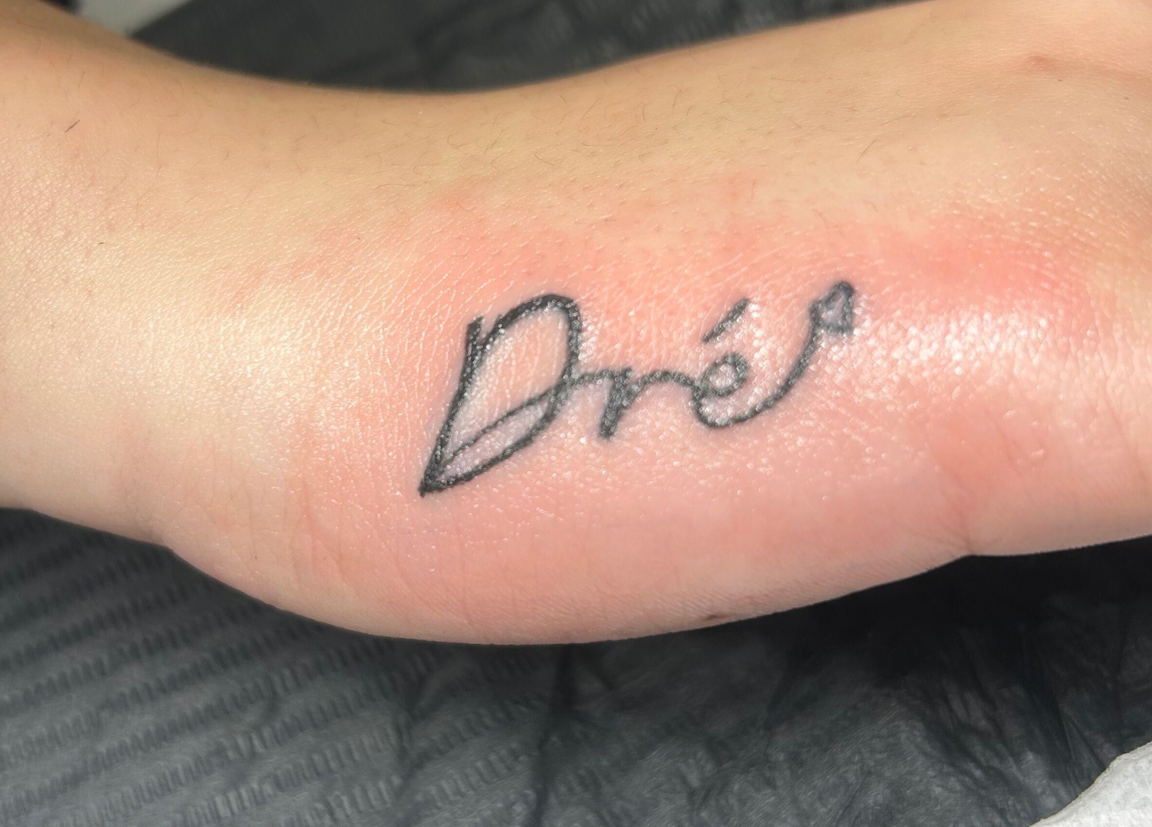 Fine line tattoo on wrist at Navy in Halesworth, England, GB showcasing delicate artistry.