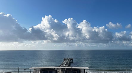 Scenic view from Selah Massage Therapy, Bournemouth, England, GB overlooking the ocean under a vast cloudy sky.