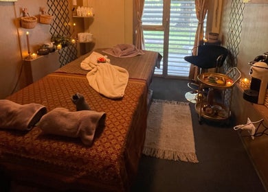 Relaxing massage room at GrandRelax@ThaiMassage, Ascona, Ticino, CH, warmly lit with cozy decor.