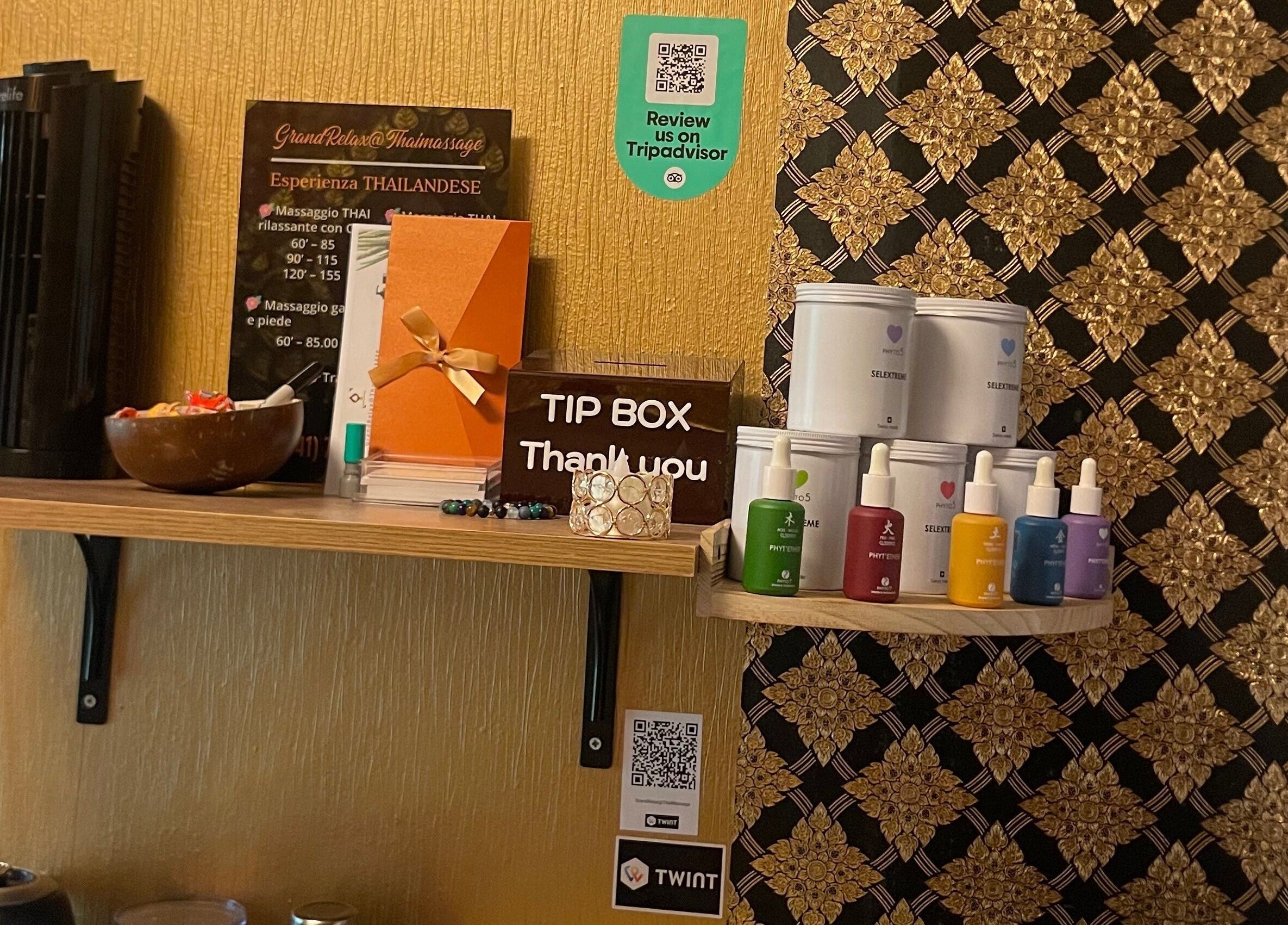 Shelf with products and tip box at GrandRelax at ThaiMassage, Ascona, Ticino, CH.