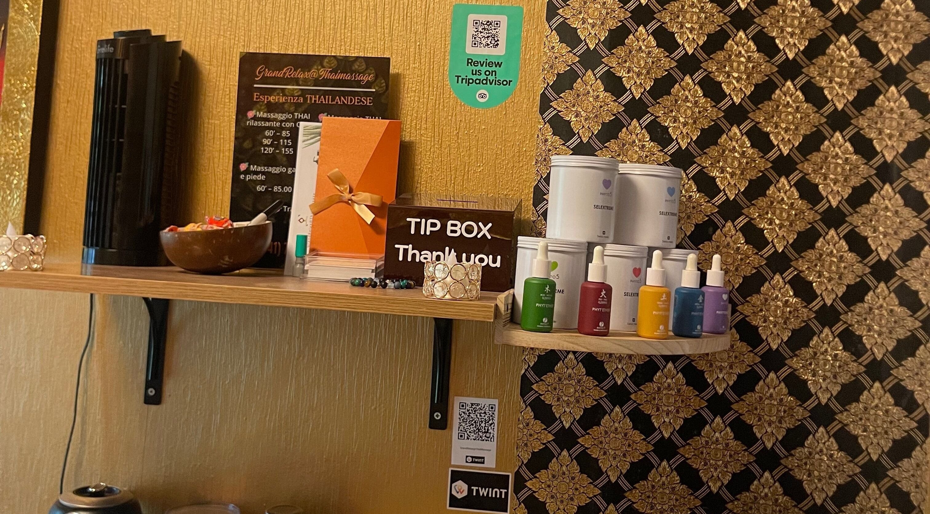 Shelf with products and tip box at GrandRelax at ThaiMassage, Ascona, Ticino, CH.