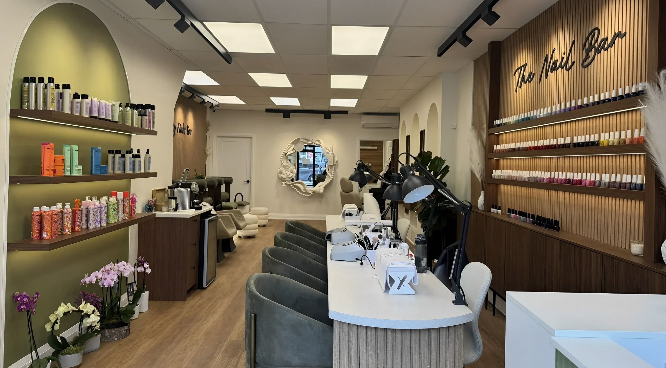 Stylish nail salon interior at Robey Beauty Inc, Toronto, Ontario, CA, featuring nail polish displays and seating.
