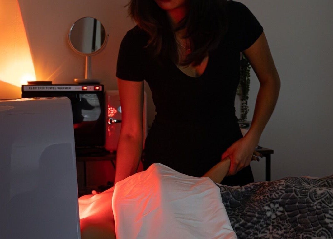 Therapist at Soluna Skin Studio in Durham, North Carolina, US using warm towel for relaxing treatment.