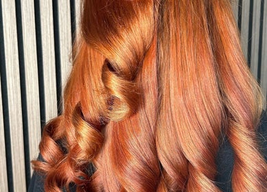 Vibrant copper curls styled at Olivia Tyman Hair Design in Elland, England, GB for a stunning salon finish.
