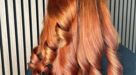 Vibrant copper curls styled at Olivia Tyman Hair Design in Elland, England, GB for a stunning salon finish.