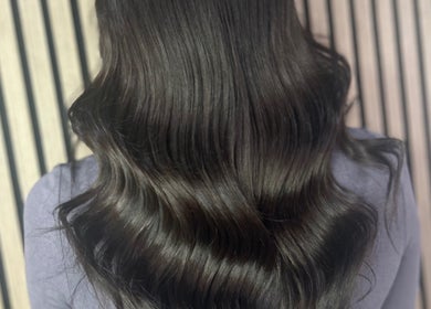 Glossy wavy hairstyle at Olivia Tyman Hair Design in Elland, England, GB showcasing expert hair care.