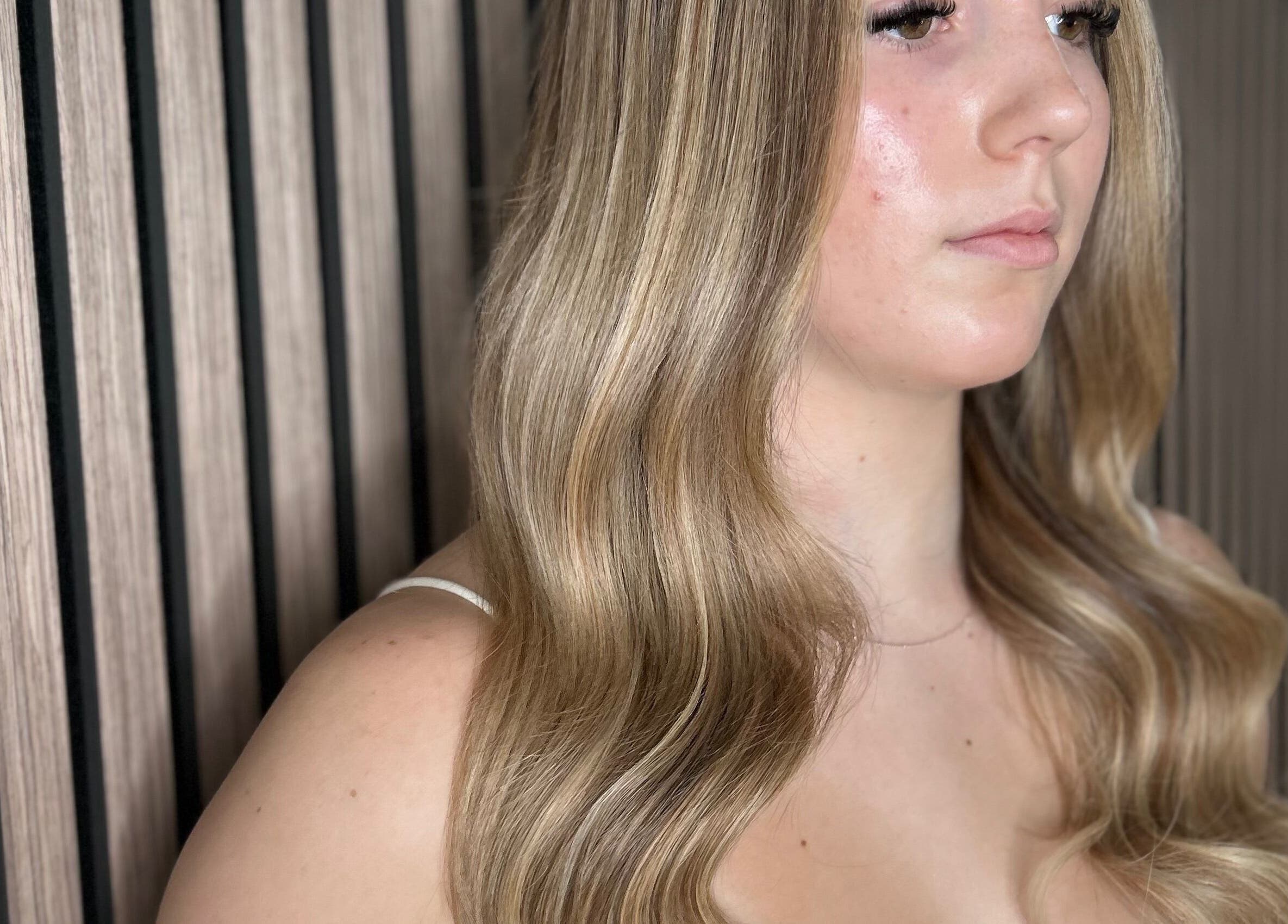 Elegant blonde hair styled at Olivia Tyman Hair Design, Elland, England, GB, showcasing soft flowing waves.