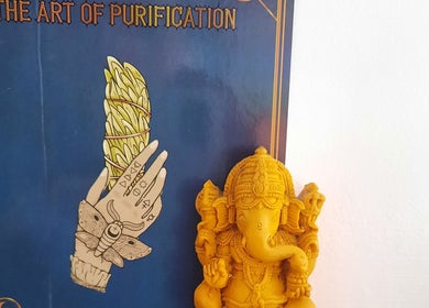 Yellow Ganesha statue with a spiritual poster at Rehab Holistic Therapies, Kilmarnock, Scotland, GB.