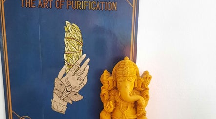 Yellow Ganesha statue with a spiritual poster at Rehab Holistic Therapies, Kilmarnock, Scotland, GB.