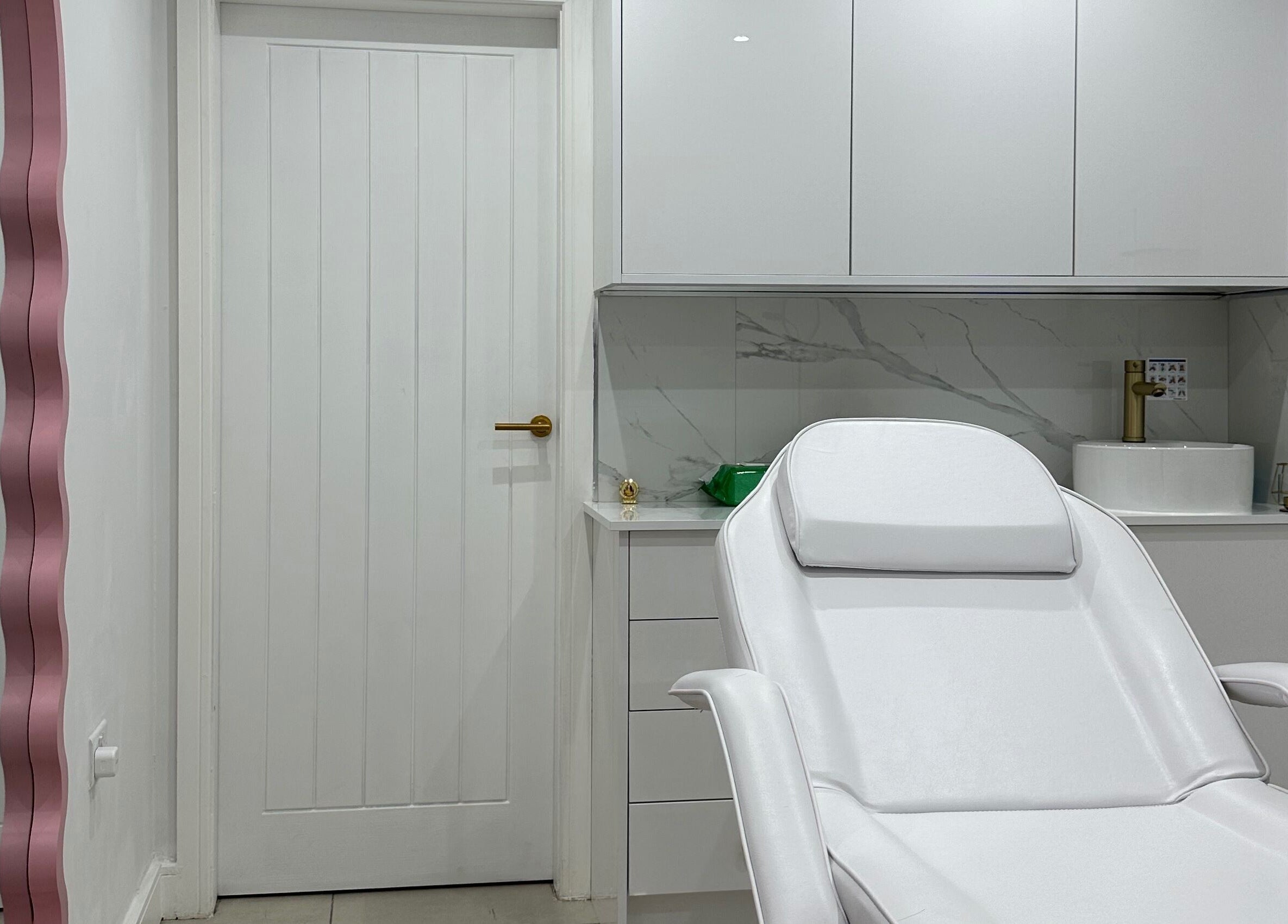 Modern treatment room at Clear Touch Medical Aesthetics, Dudley, England, GB featuring sleek white design.