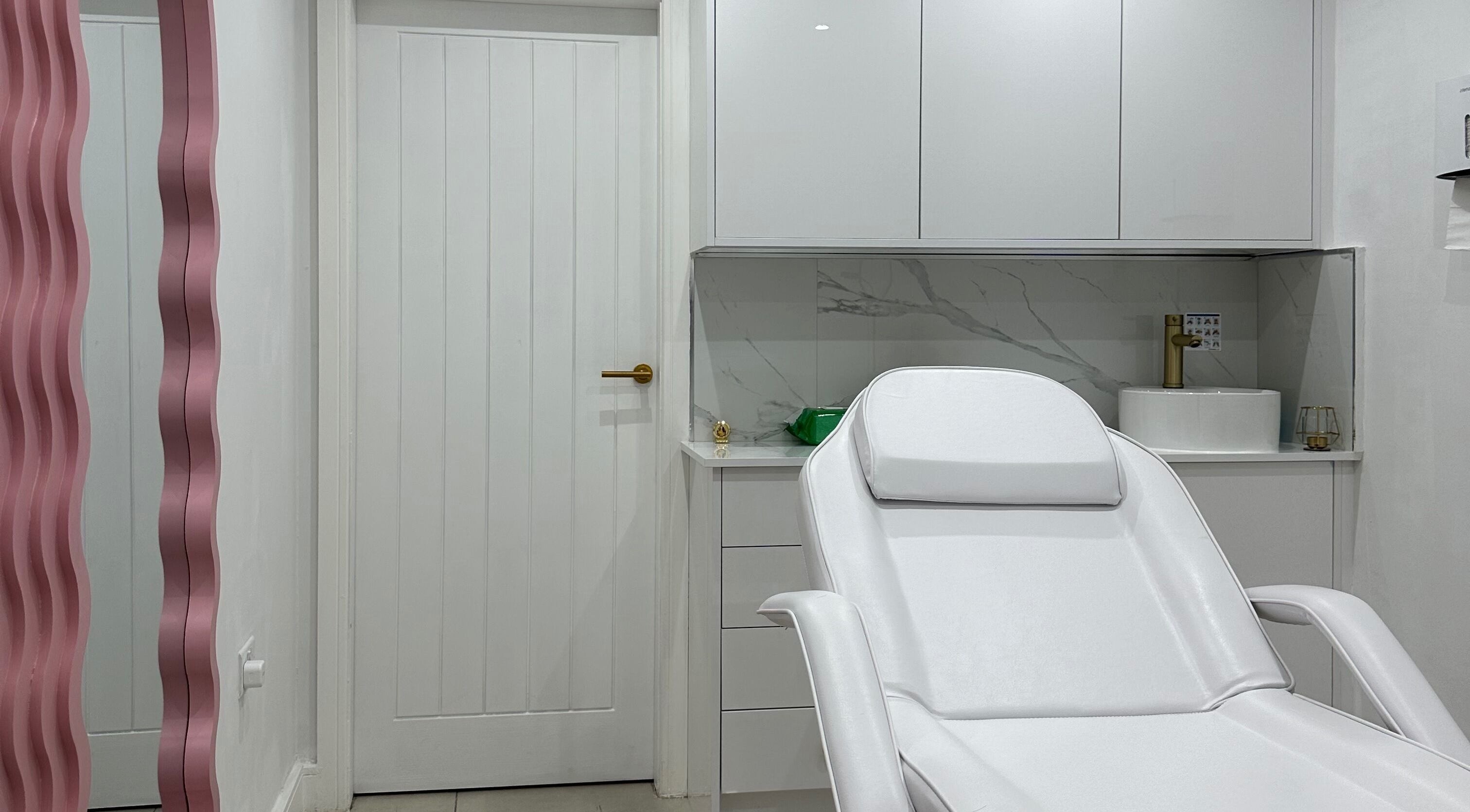 Modern treatment room at Clear Touch Medical Aesthetics, Dudley, England, GB featuring sleek white design.