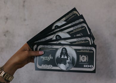 Hand holding Browers branded money at Browers, Dubbo, New South Wales, AU, showcasing beauty and wellness services.
