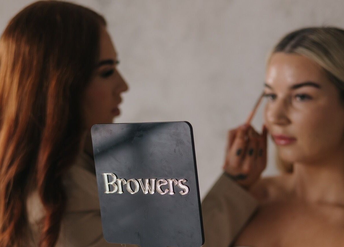 Makeup artist at Browers in Dubbo, New South Wales, AU applying makeup on a client with precision.