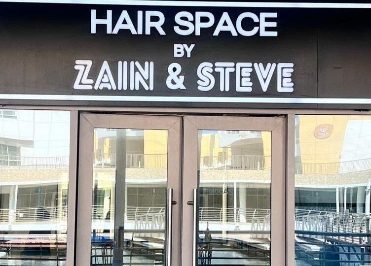 Entrance of Hair Space Ladies Salon by Zain & Steve in Abu Dhabi, AE with stylish glass doors.