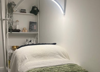 Cozy treatment room at Emerald Skin Studio in London, England, GB, showcasing a serene and inviting ambiance.