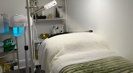 Relaxing spa room at Emerald Skin Studio, London, England, GB featuring a massage table and soothing decor.