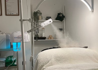 Modern treatment room at Emerald Skin Studio, London, England, GB with steaming equipment and serene setup.