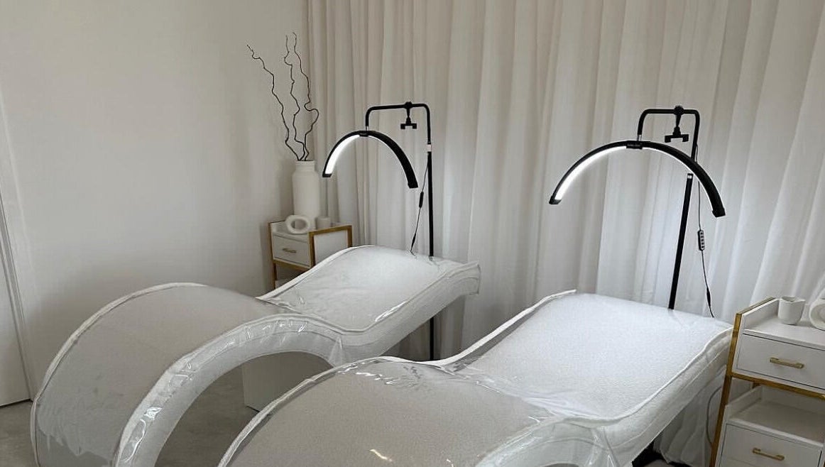 Modern treatment beds at Glos Brows & Body in Exeter, England, GB, with soft lighting and elegant decor.