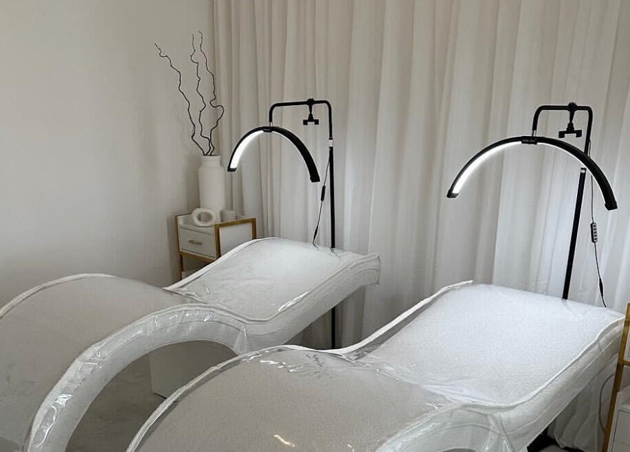 Modern treatment beds at Glos Brows & Body in Exeter, England, GB, with soft lighting and elegant decor.