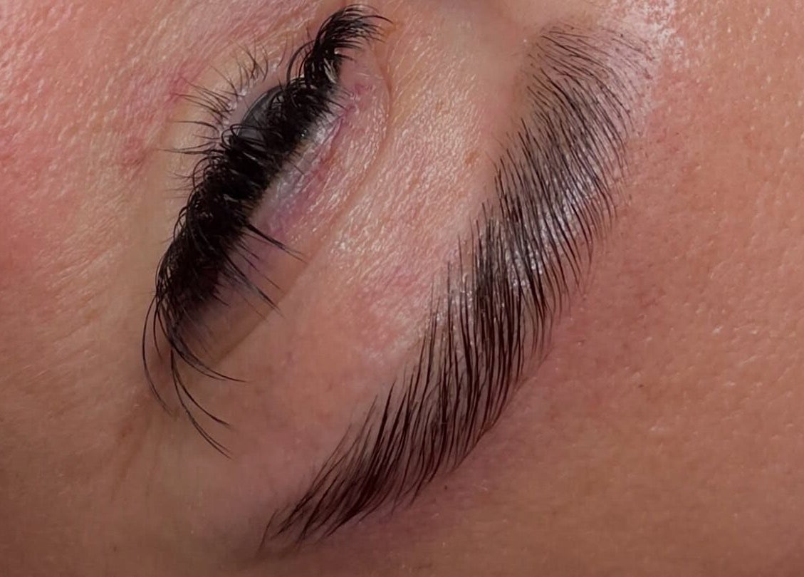 Close-up of a perfectly shaped eyebrow and lashes at Glos Brows & Body, Exeter, England, GB.