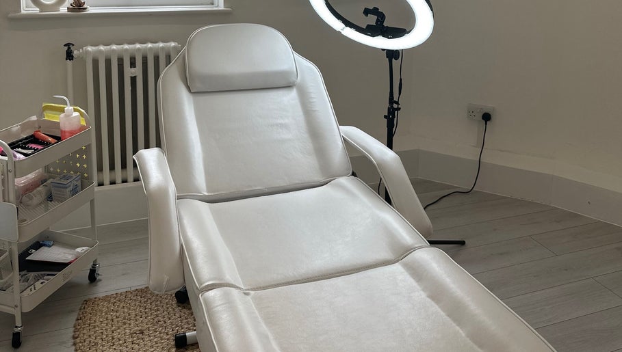 Spacious treatment room at Blushed By Talia, Workington, England, GB with a white therapy bed.