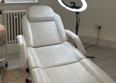 Spacious treatment room at Blushed By Talia, Workington, England, GB with a white therapy bed.