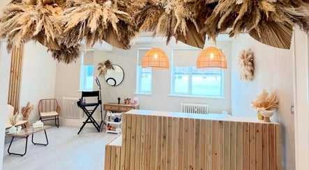 Reception area of Blushed By Talia, Workington, England, GB with natural decor and soft lighting.