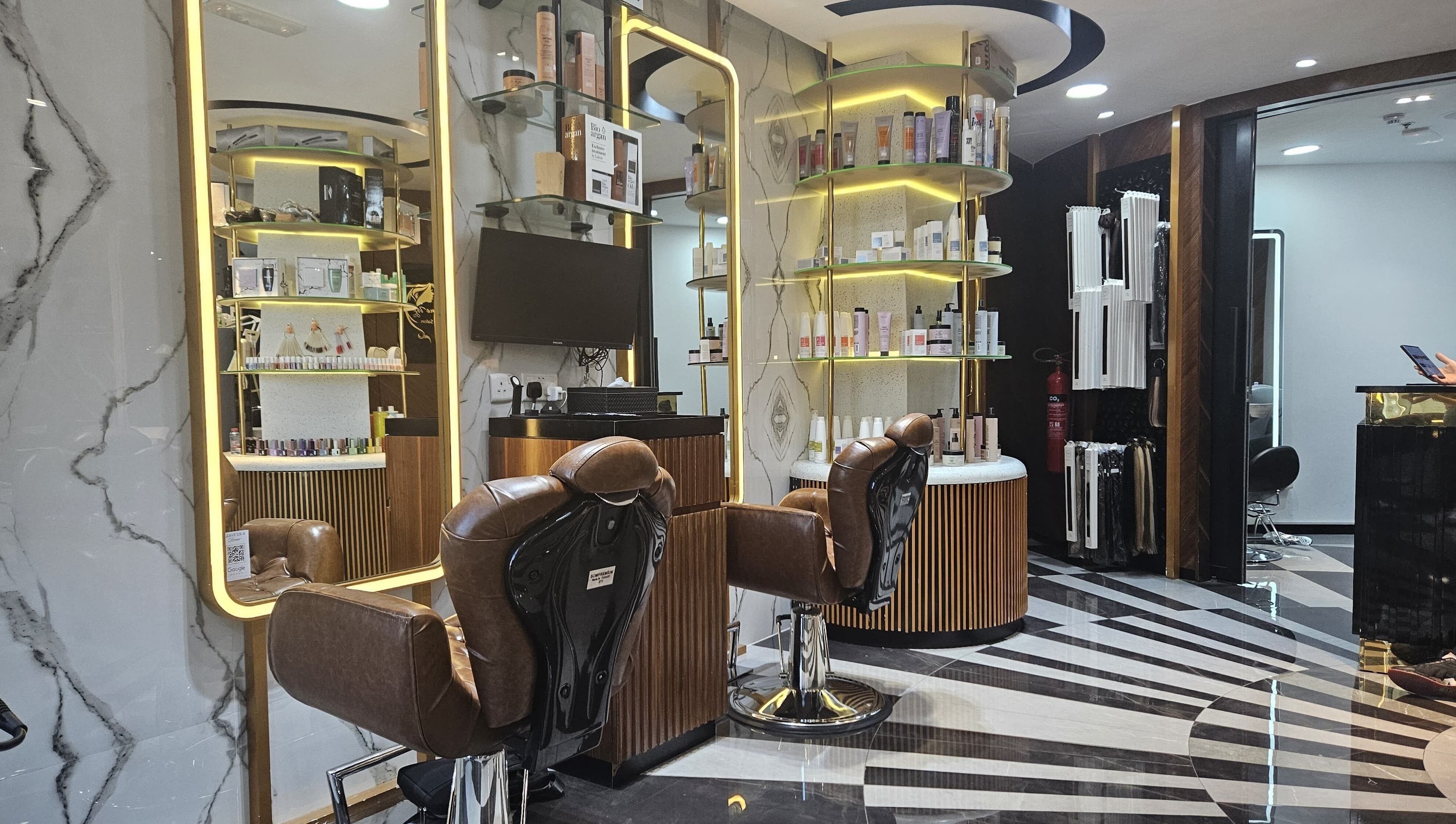 Luxurious interior of Style Me Up Beauty Salon in Dubai, Dubai, AE with stylish chairs and shelves of beauty products.