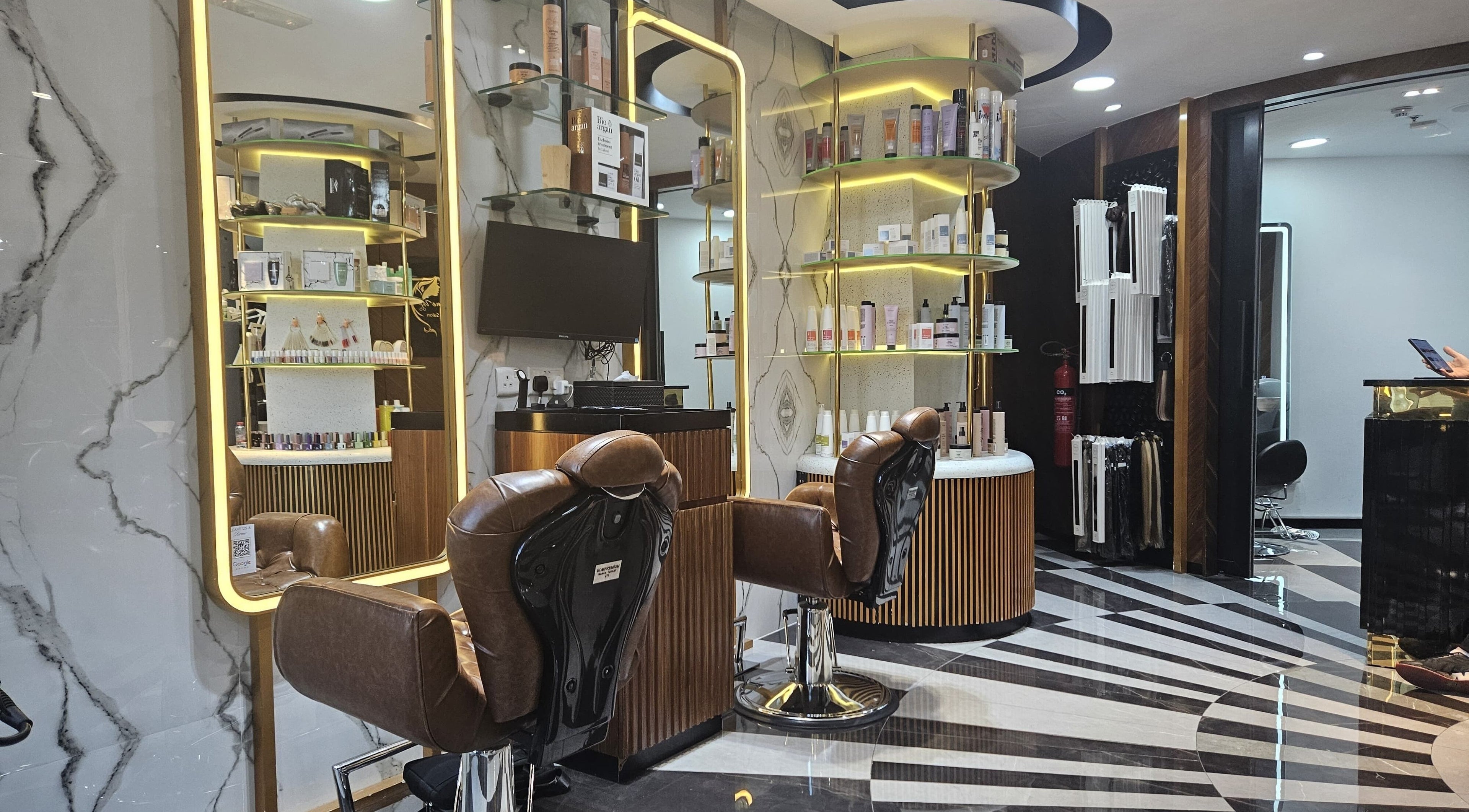 Luxurious interior of Style Me Up Beauty Salon in Dubai, Dubai, AE with stylish chairs and shelves of beauty products.