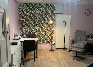 Stylish interior of Nicole's Nails & Beauty in Eastbourne, England, GB with floral decor and comfortable seating.