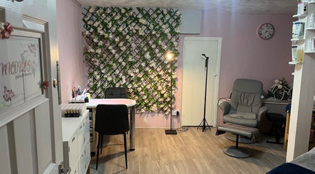 Stylish interior of Nicole's Nails & Beauty in Eastbourne, England, GB with floral decor and comfortable seating.