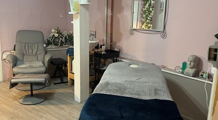 Relaxing treatment room at Nicole's Nails & Beauty, Eastbourne, England, GB with chair and massage table.