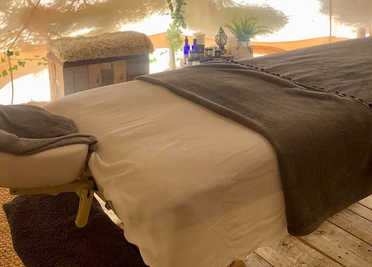 Cozy massage table setup at The Nurture Sanctuary, Broadwindsor, England, GB, enhancing relaxation.