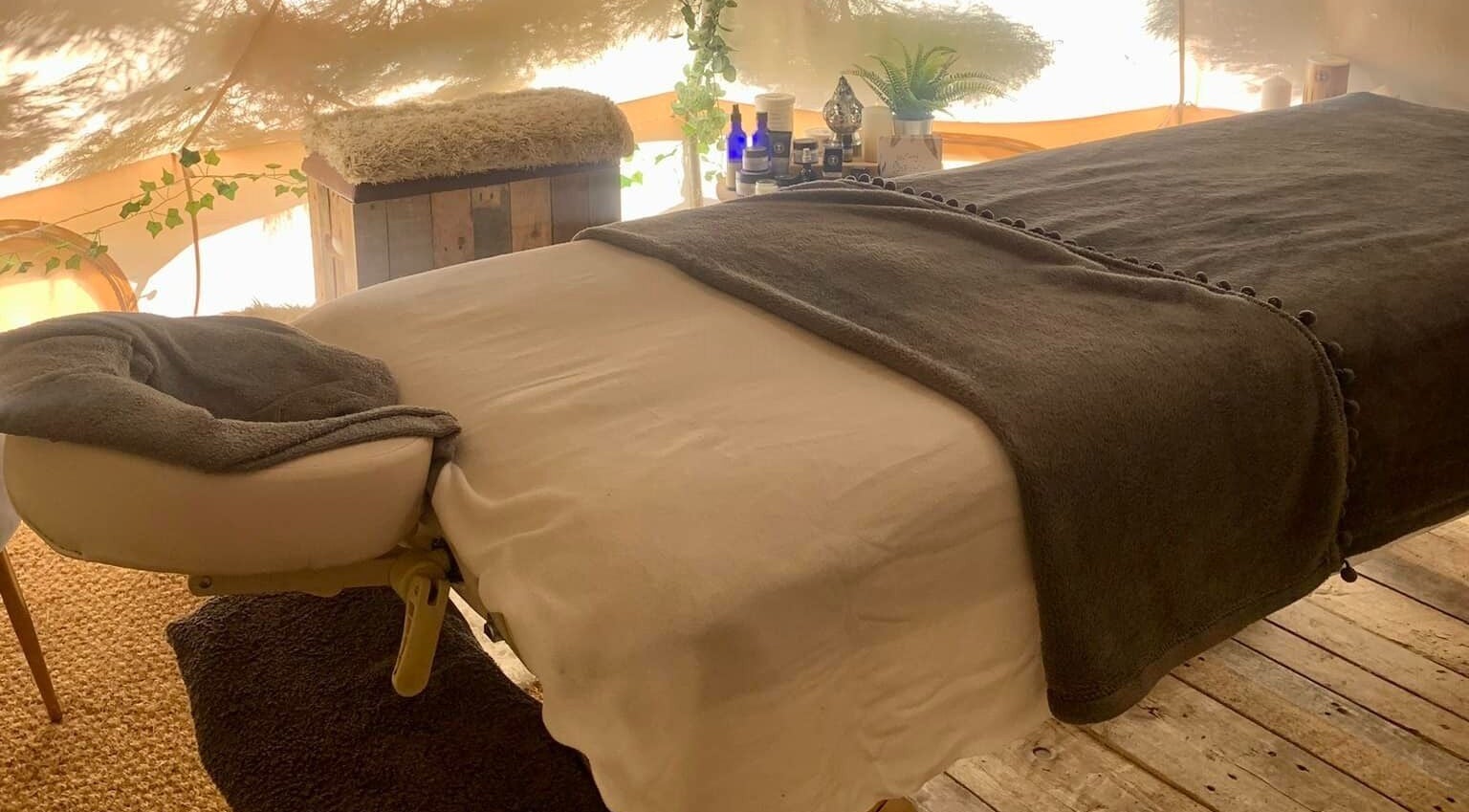 Cozy massage table setup at The Nurture Sanctuary, Broadwindsor, England, GB, enhancing relaxation.