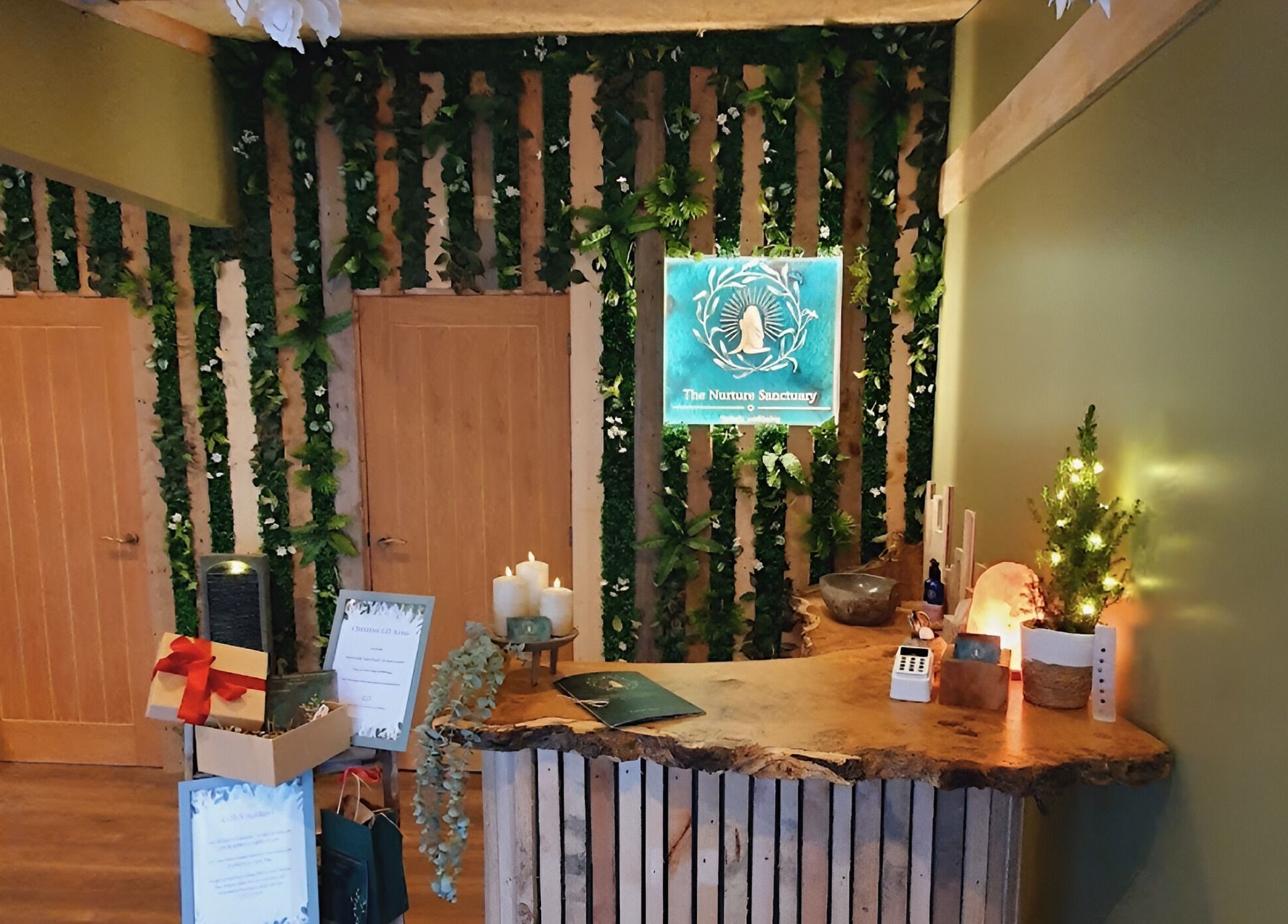 Warm rustic reception at The Nurture Sanctuary in Broadwindsor, England, GB, with greenery and wood accents.