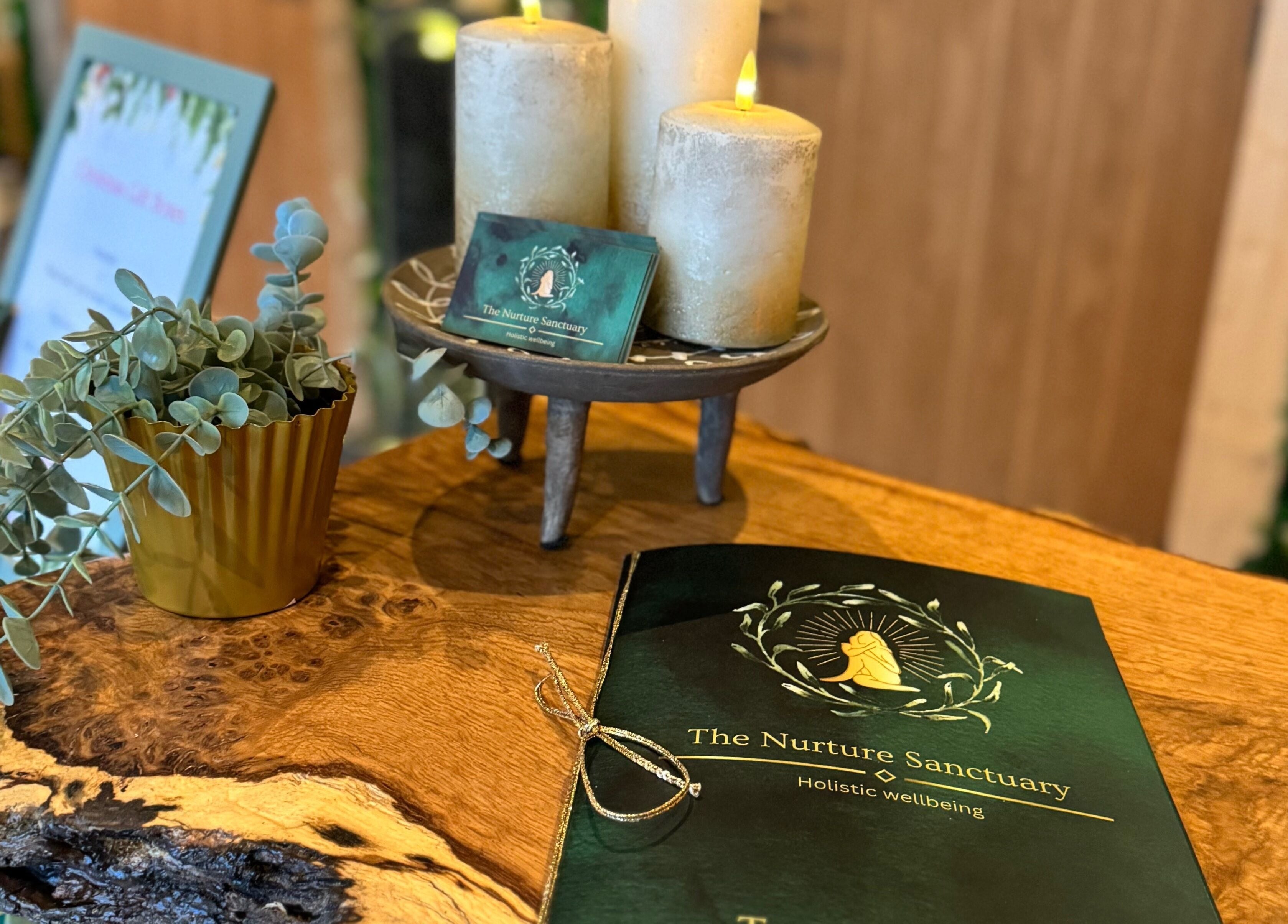 Candles and brochure at The Nurture Sanctuary, Broadwindsor, England, GB, showcasing holistic wellbeing ambiance.