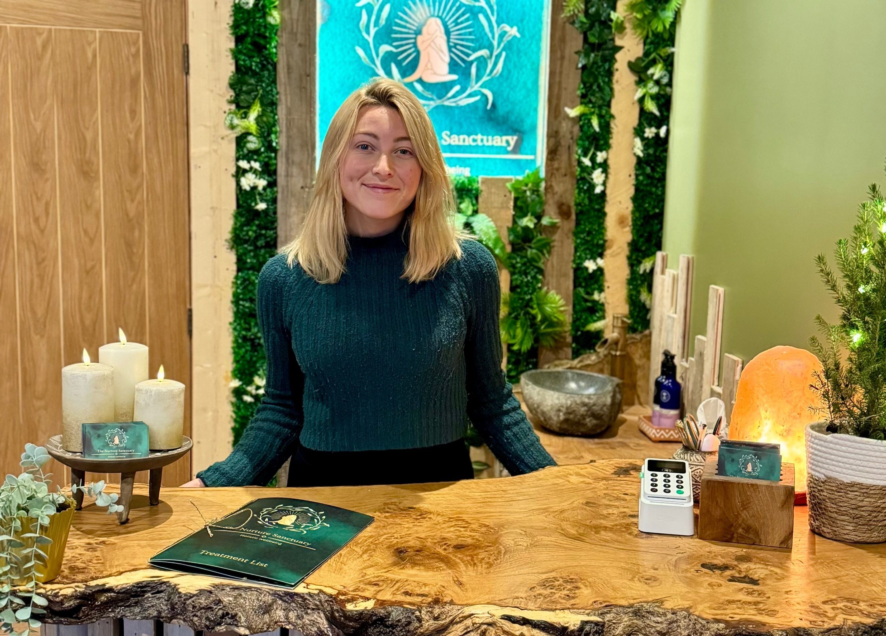 Reception at The Nurture Sanctuary, Broadwindsor, England, GB, with staff, candles, and cozy decor.