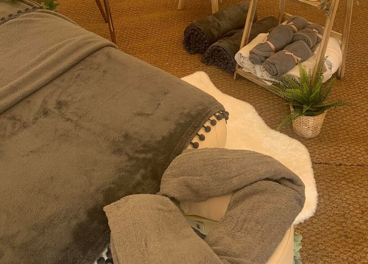 Luxurious massage table at The Nurture Sanctuary, Broadwindsor, England, GB set up with plush towels.