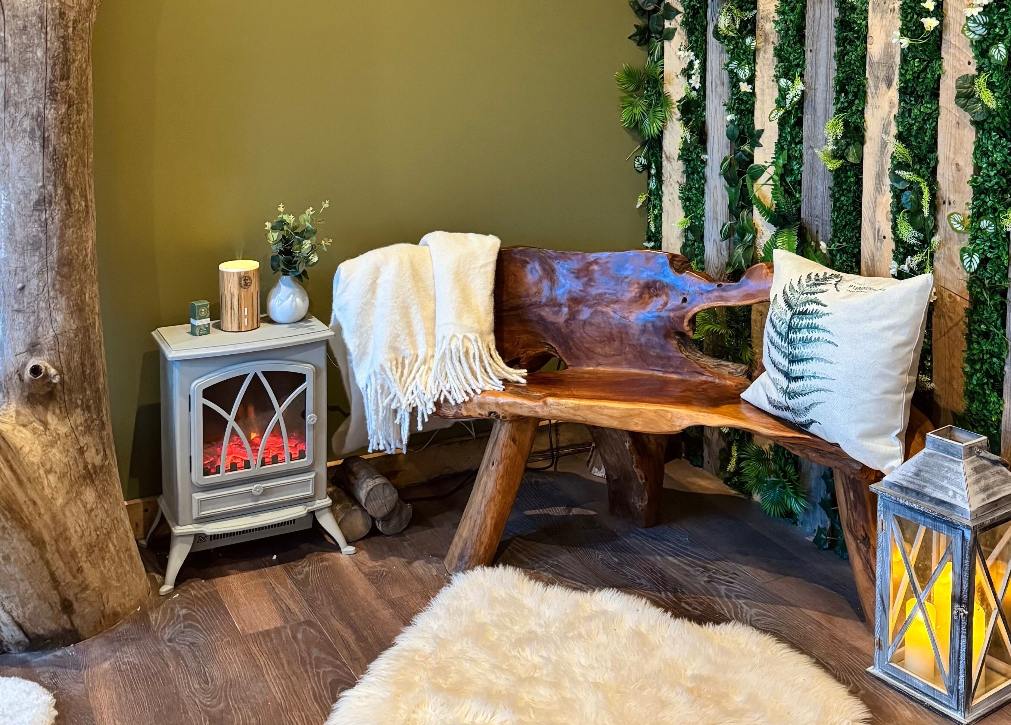 Cozy wooden bench in The Nurture Sanctuary, Broadwindsor, England, GB, with green decor and warm lighting.