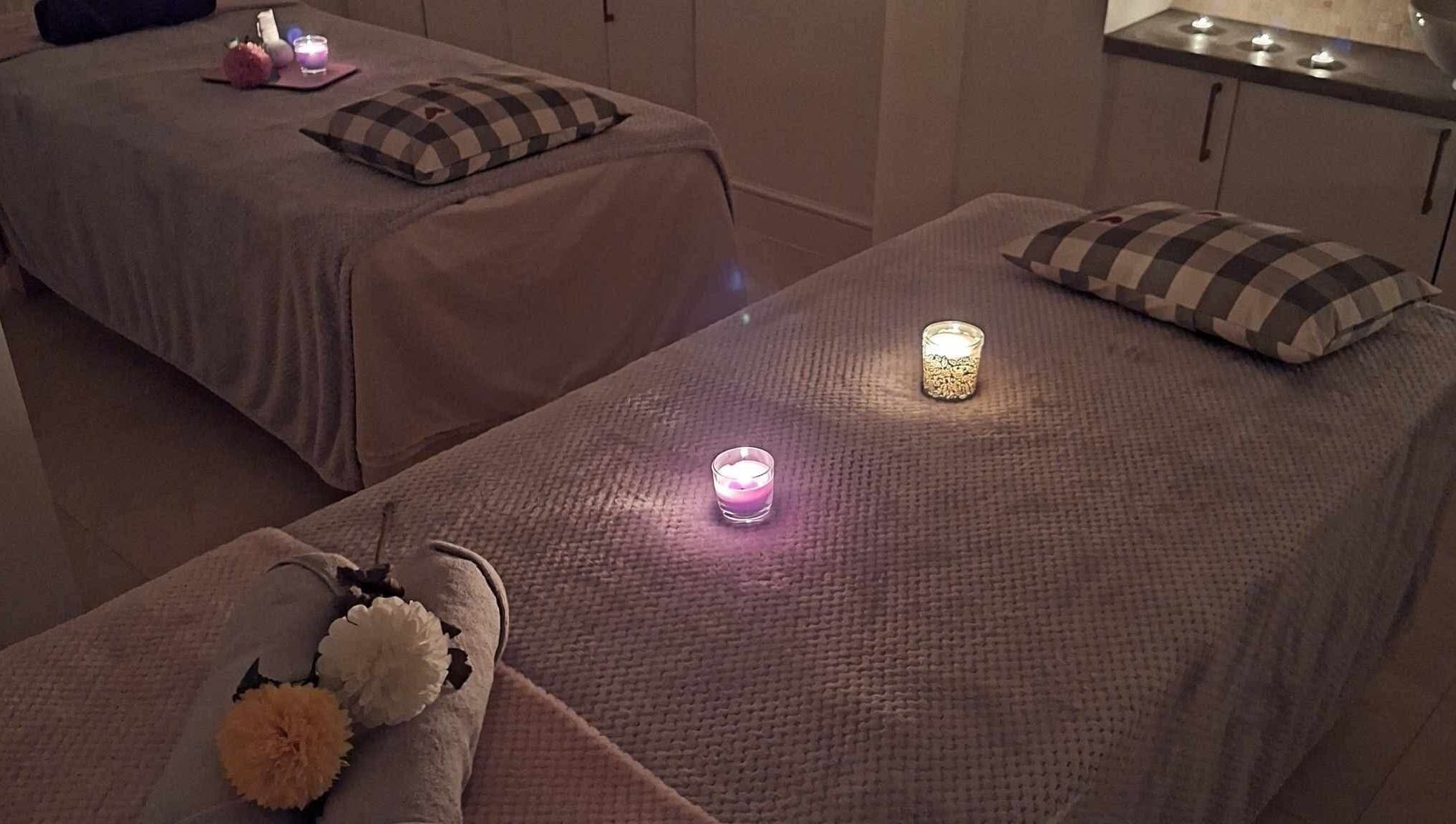 Relaxing massage room setup with candles at Finn Spa in Manchester, Chadderton, England, GB.