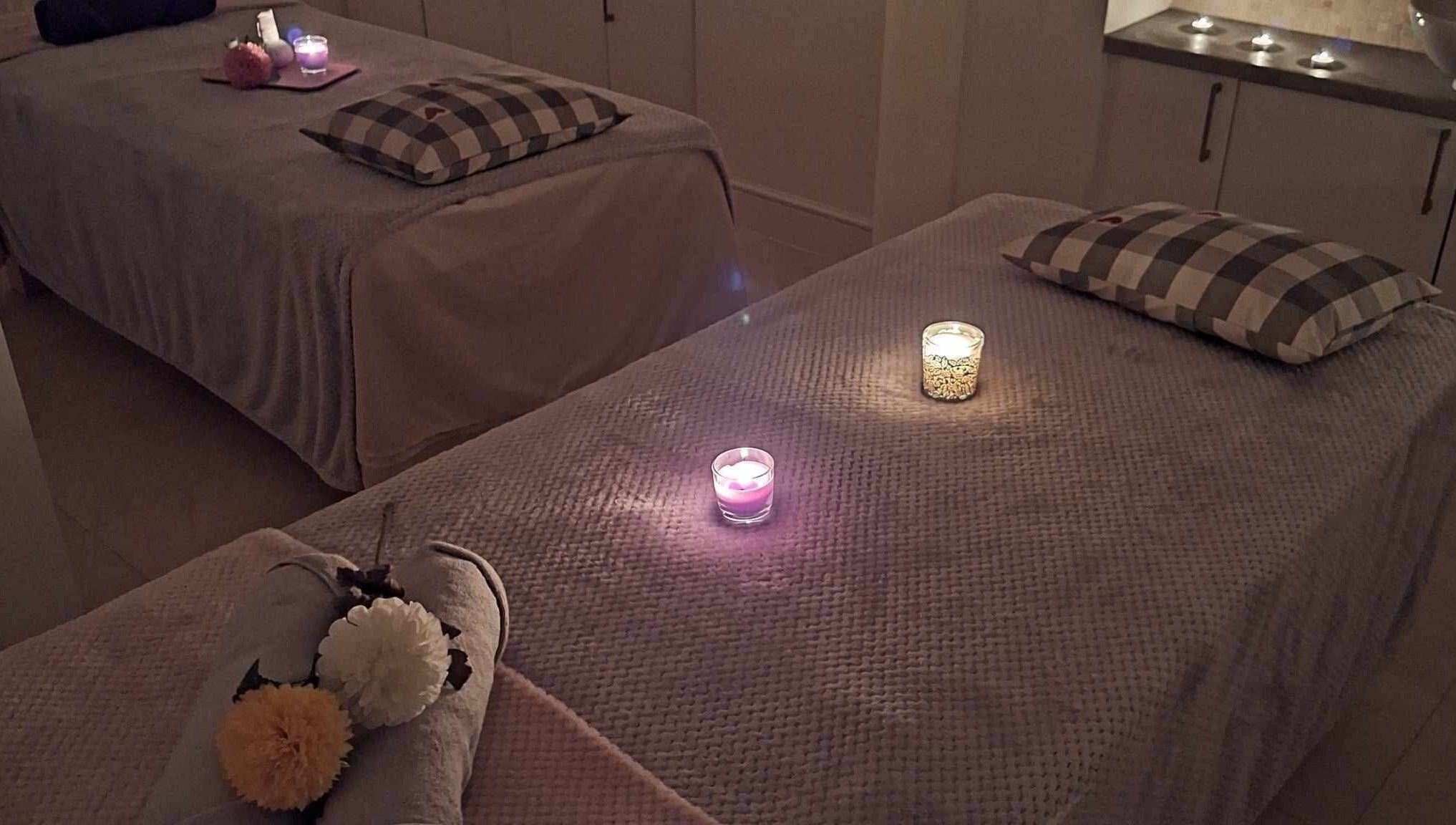 Relaxing massage room setup with candles at Finn Spa in Manchester, Chadderton, England, GB.